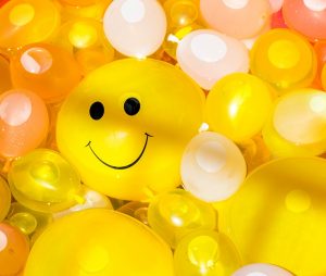 yellow helium balloon smiling face
